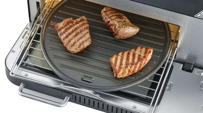 Zum Lieferumfang des Pizzaofens gehören neben einem hochwertigen Pizzastein auch eine Grillplatte sowie ein Heißluftkorb. Beide machen aus dem kompakten Ofen wahlweise einen Grill oder eine Heißluftfritteuse.